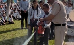 Fire safety mock drill conducted by the Fire Department at Samsara Public School, Shekhukheda; students shown fire-extinguishing techniques.